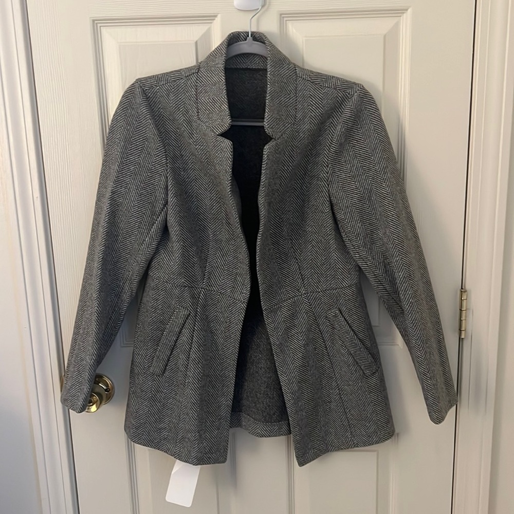 Grey polyester jacket. Herringbone pattern. Brand new.